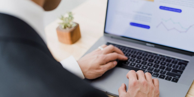 Accountant typing data into their computer