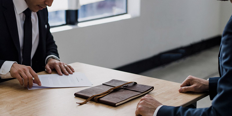 Two accountants in a meeting looking over paperwork