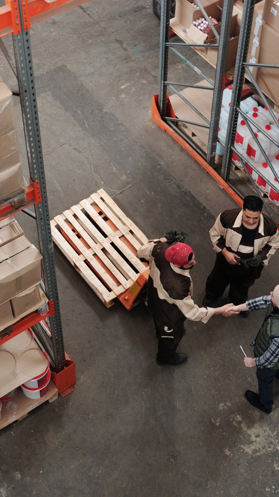 Three People Talking in Warehouse